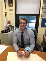 Headshot image of counselor Timothy wearing a blue collared  shirt