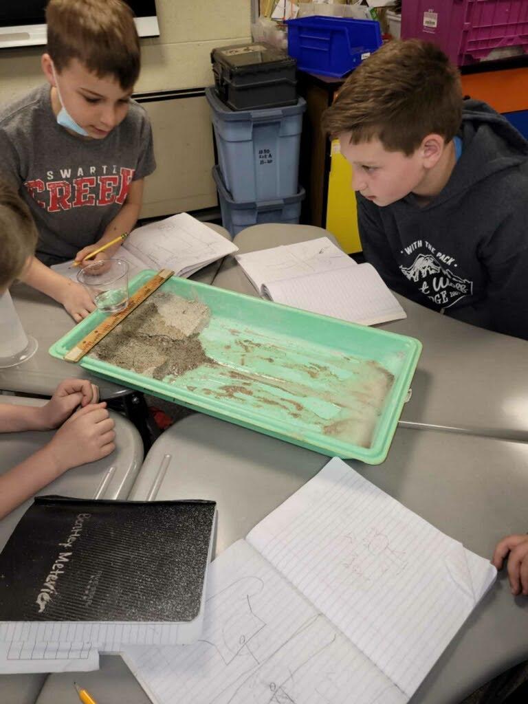 Two students practicing Erosion and Weathering in Mr. Love's fourth grade class.