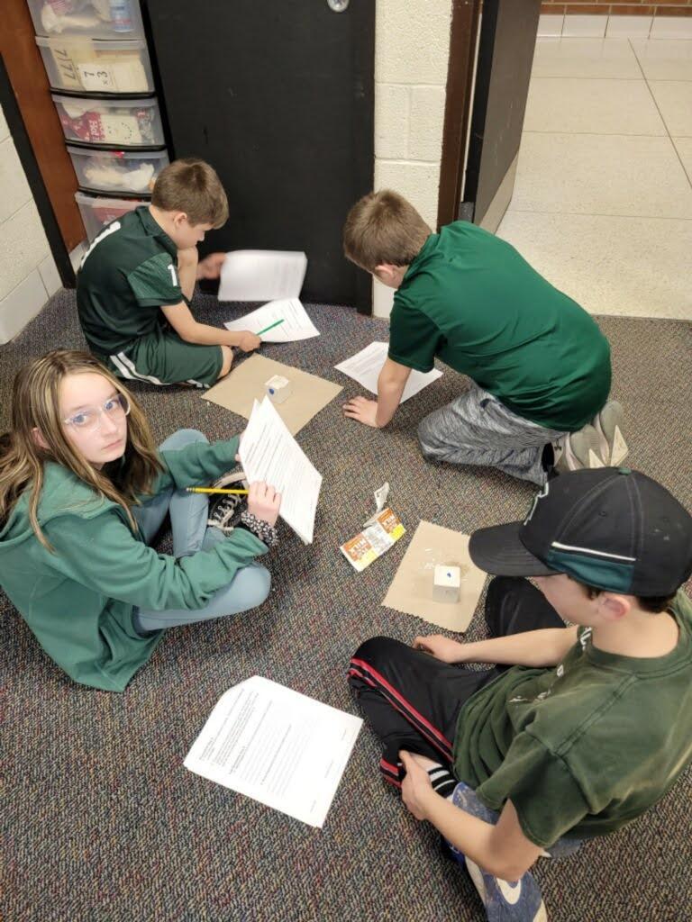 Students in a group working on projects.