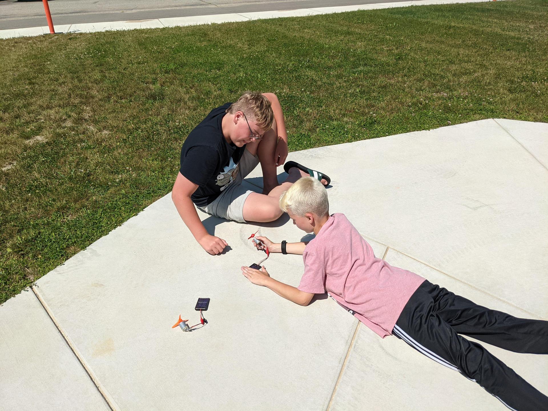 Students on the sidewalk working on projects