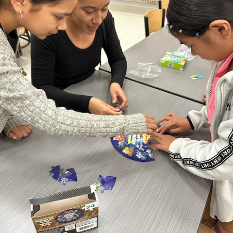 parents work with students to put together a puzzle