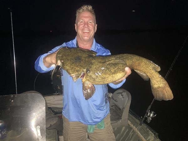 Mr. Schwabe holding a fish he caught