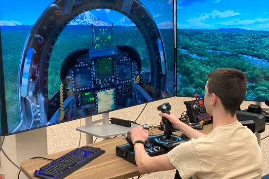 a student uses a flight simulator