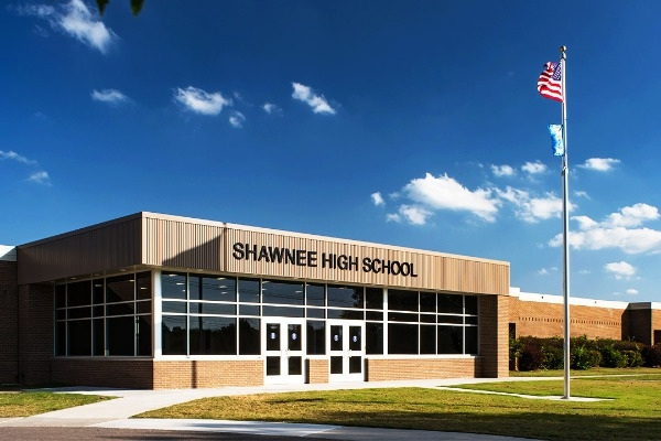the entrance of Shawnee High School against a blue sky