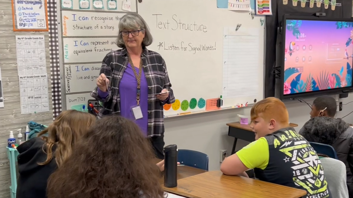 a teacher stands in front of a classroom