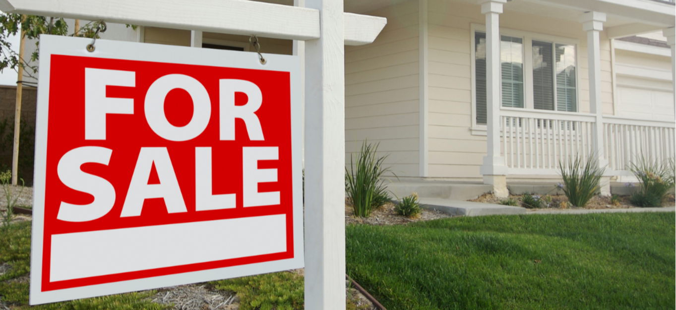 a house with a for sale sign