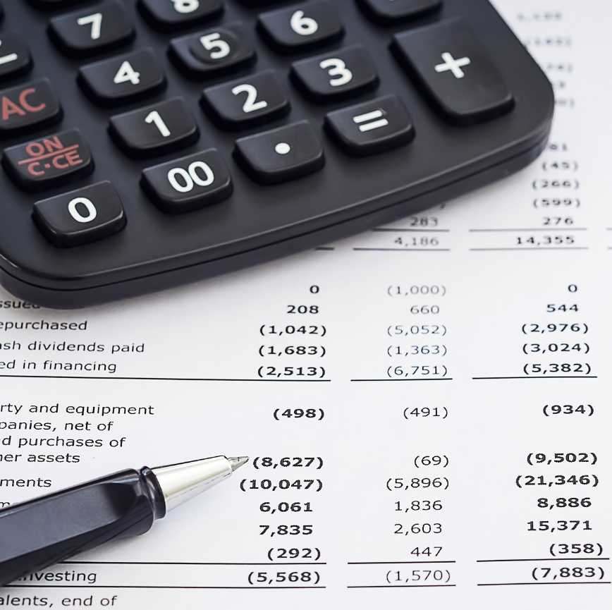 a calculator and pen lay on top of a paper with a budget