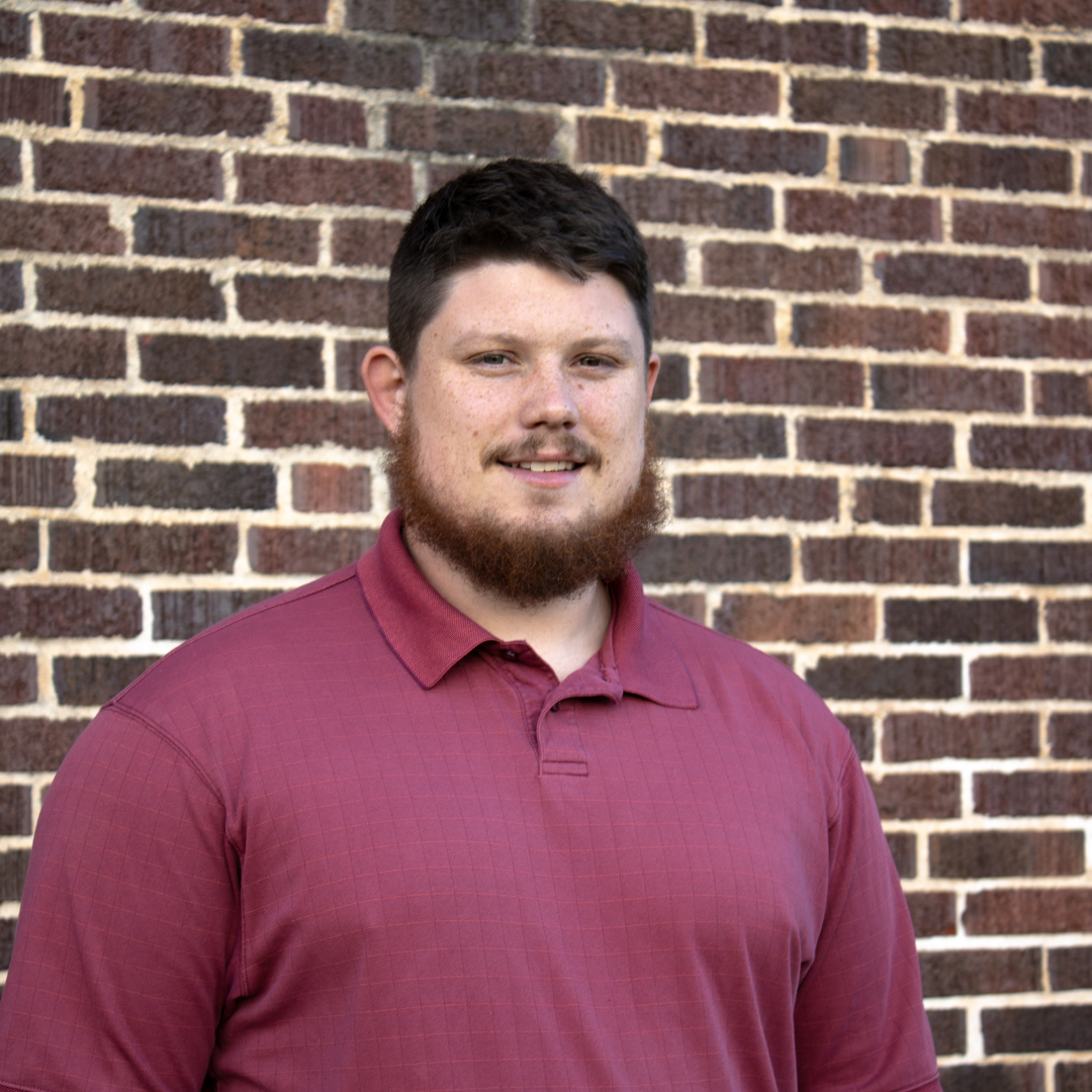 man in front of brick wall