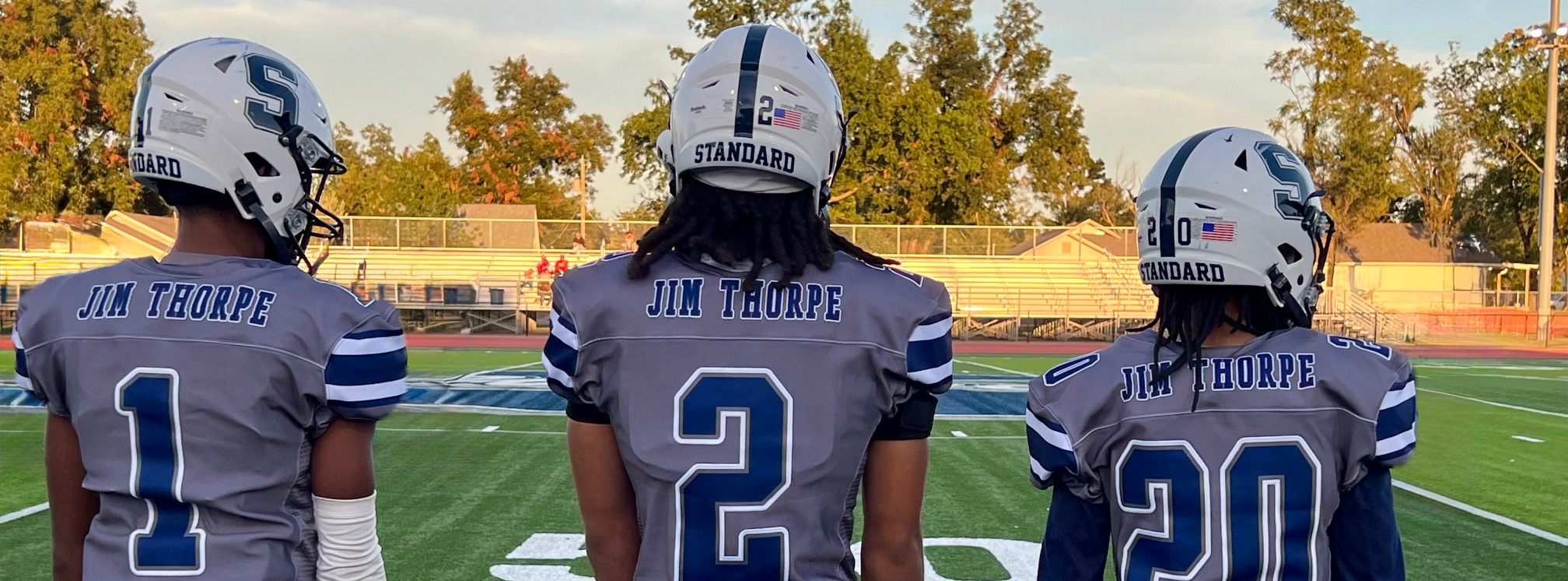 three football players backs