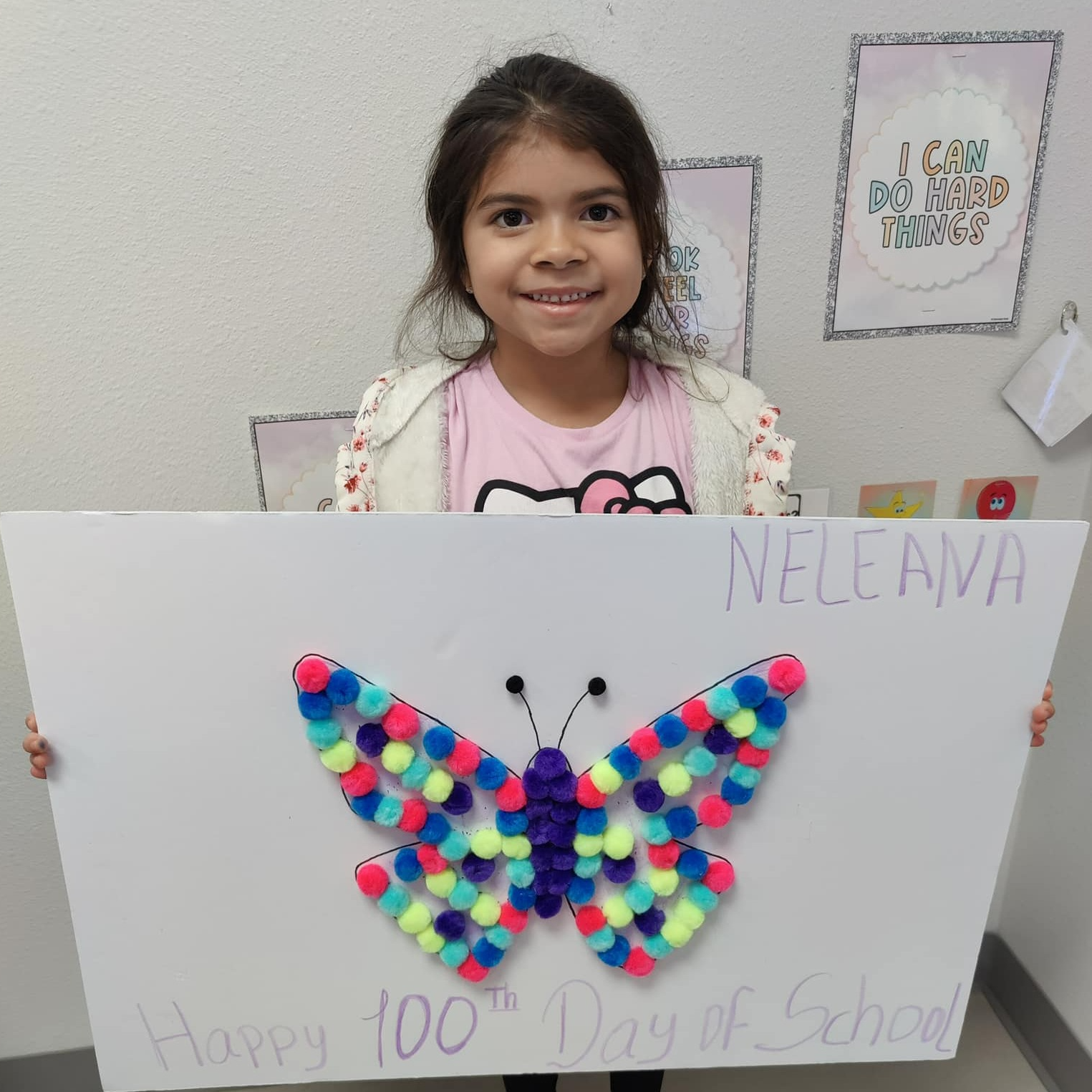 girl holding poster with colorful butterfly