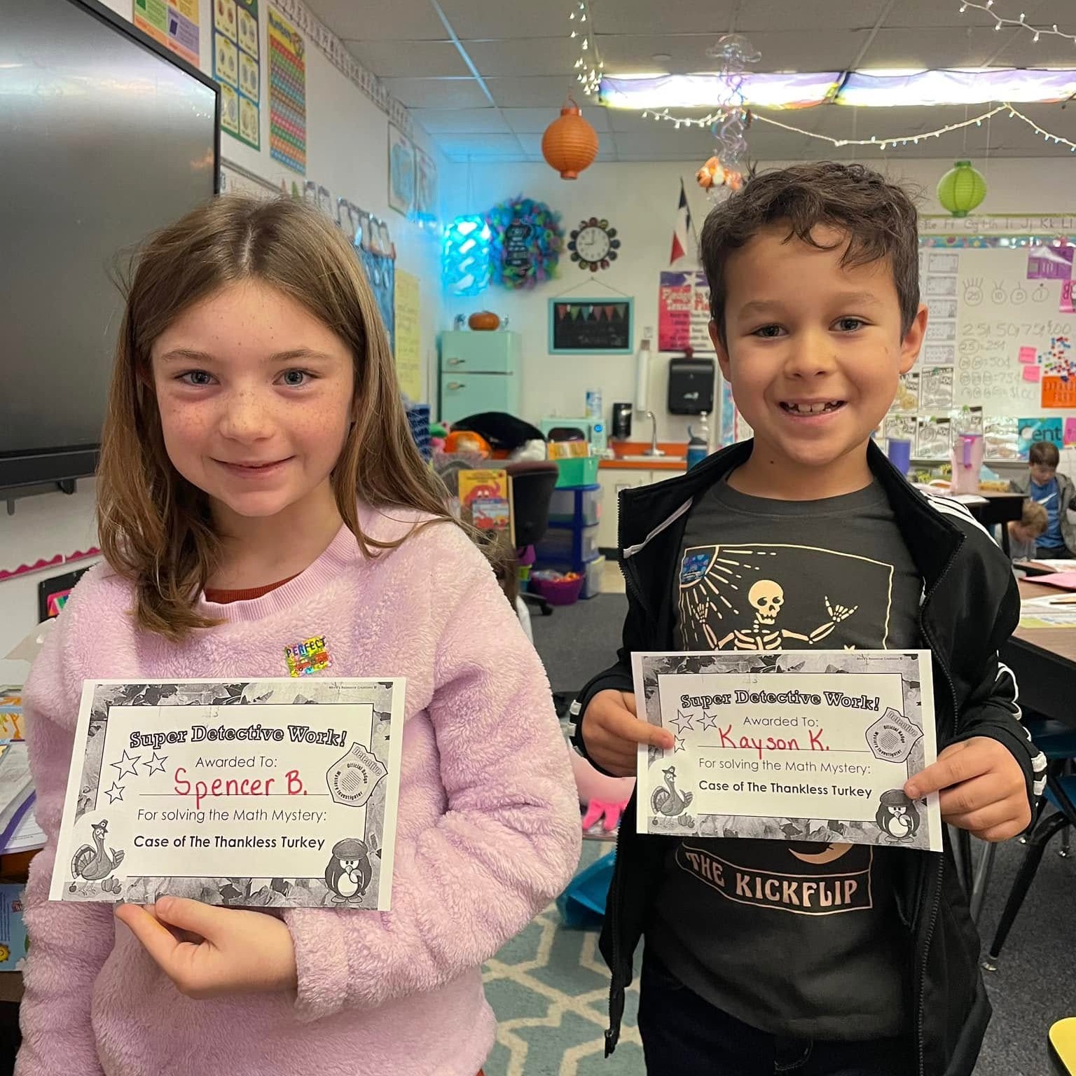 Two kids holding awards
