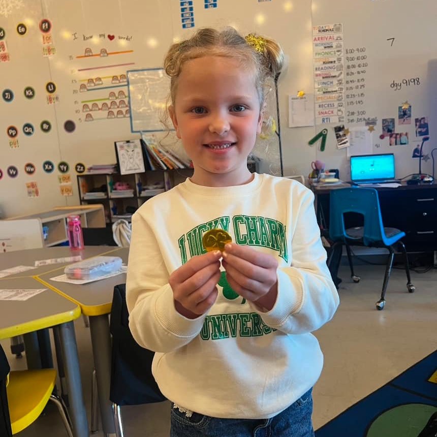Child holding a gold coin
