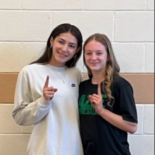 two girls holding up #1