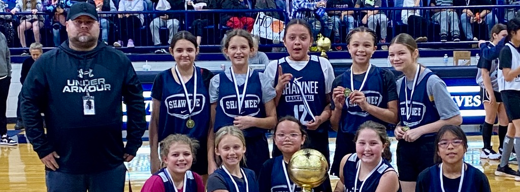 image of girls basketball players holding a trophy