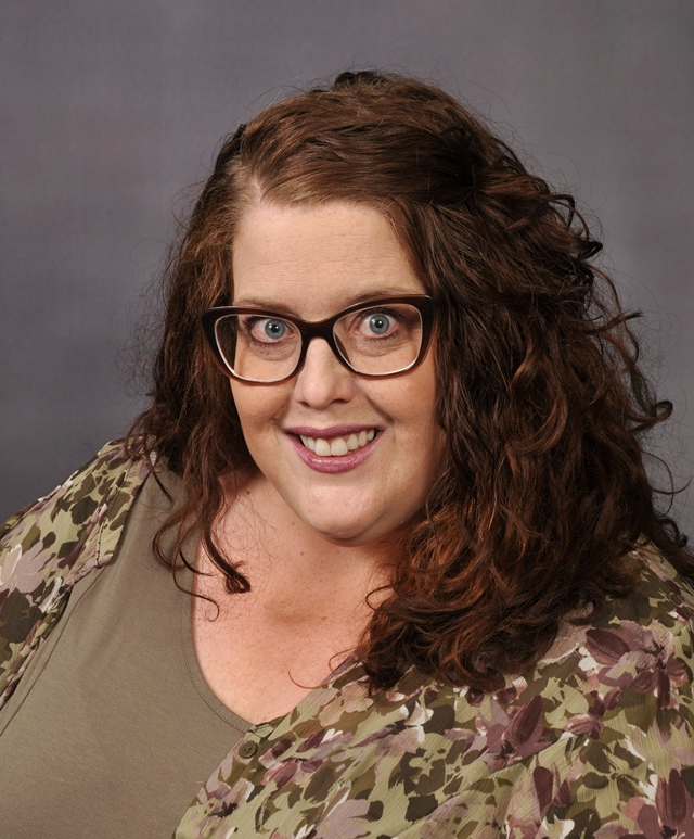 headshot of a woman wearing glasses