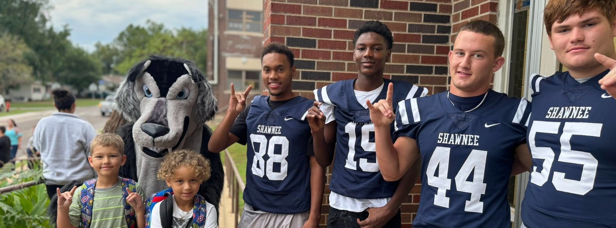 Boys holding wolves up