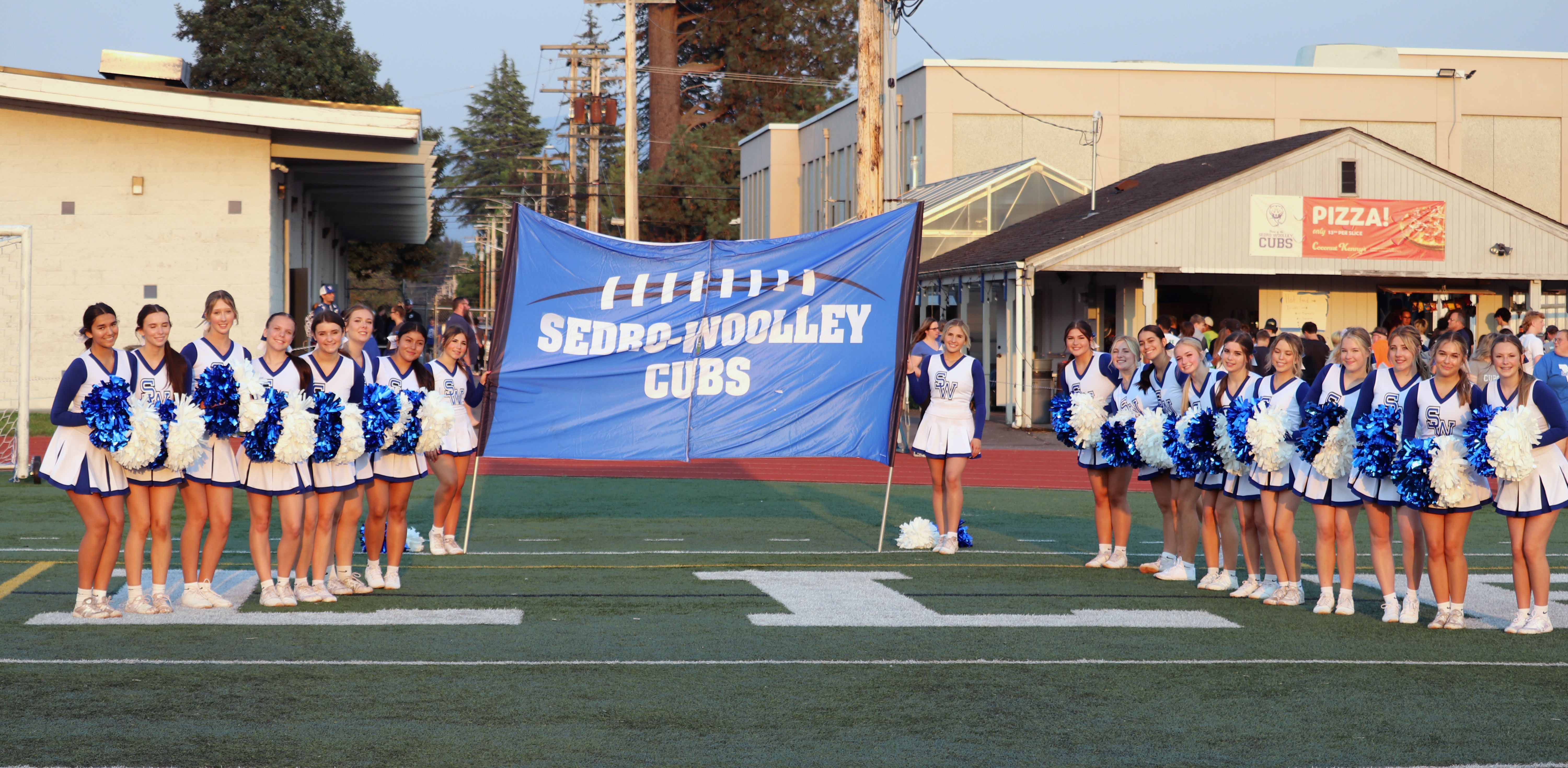 Cheerleaders holding a sign at the start of the football game against Mariner High School on September 6, 2024.