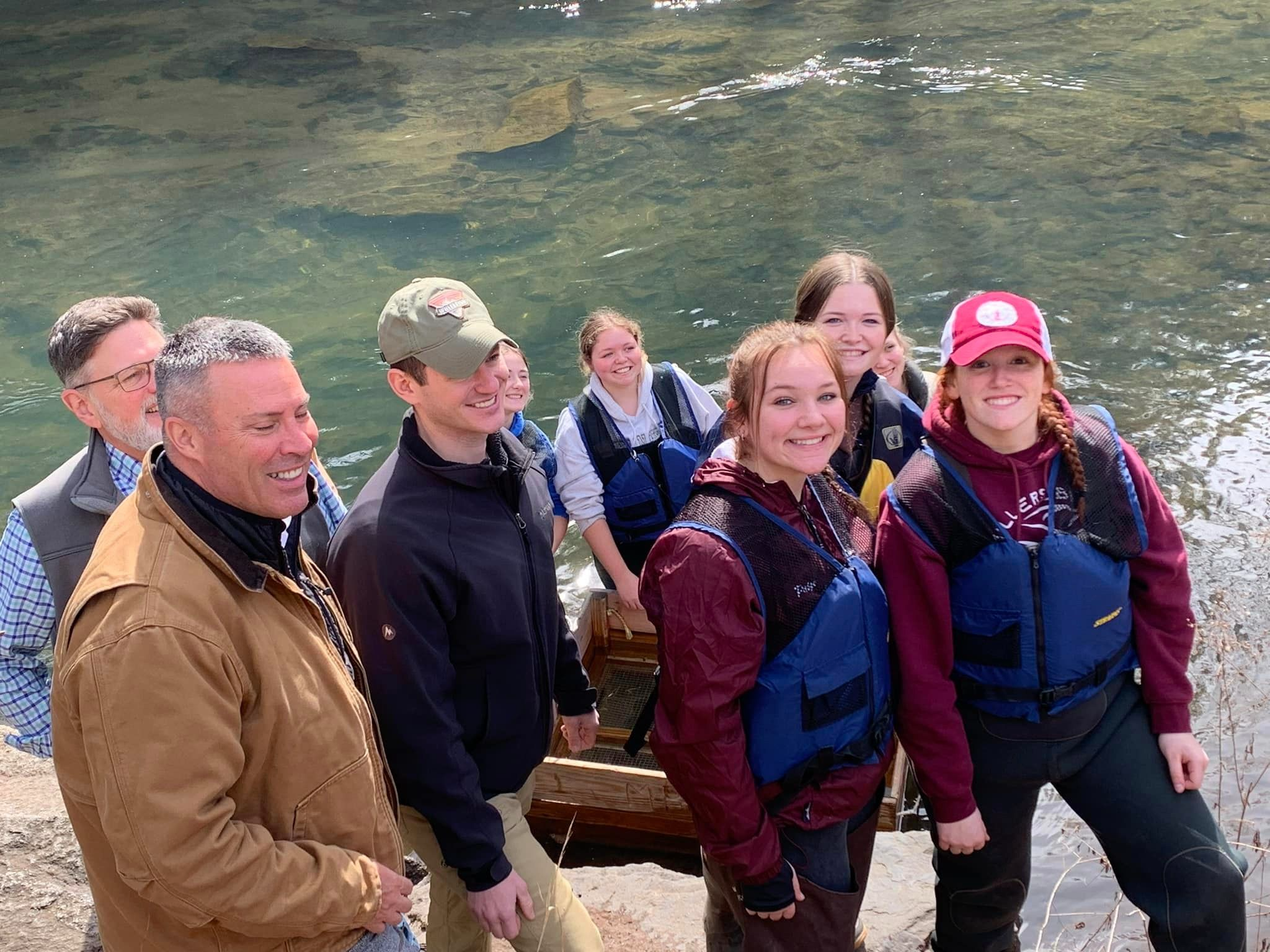 students standing in a lake