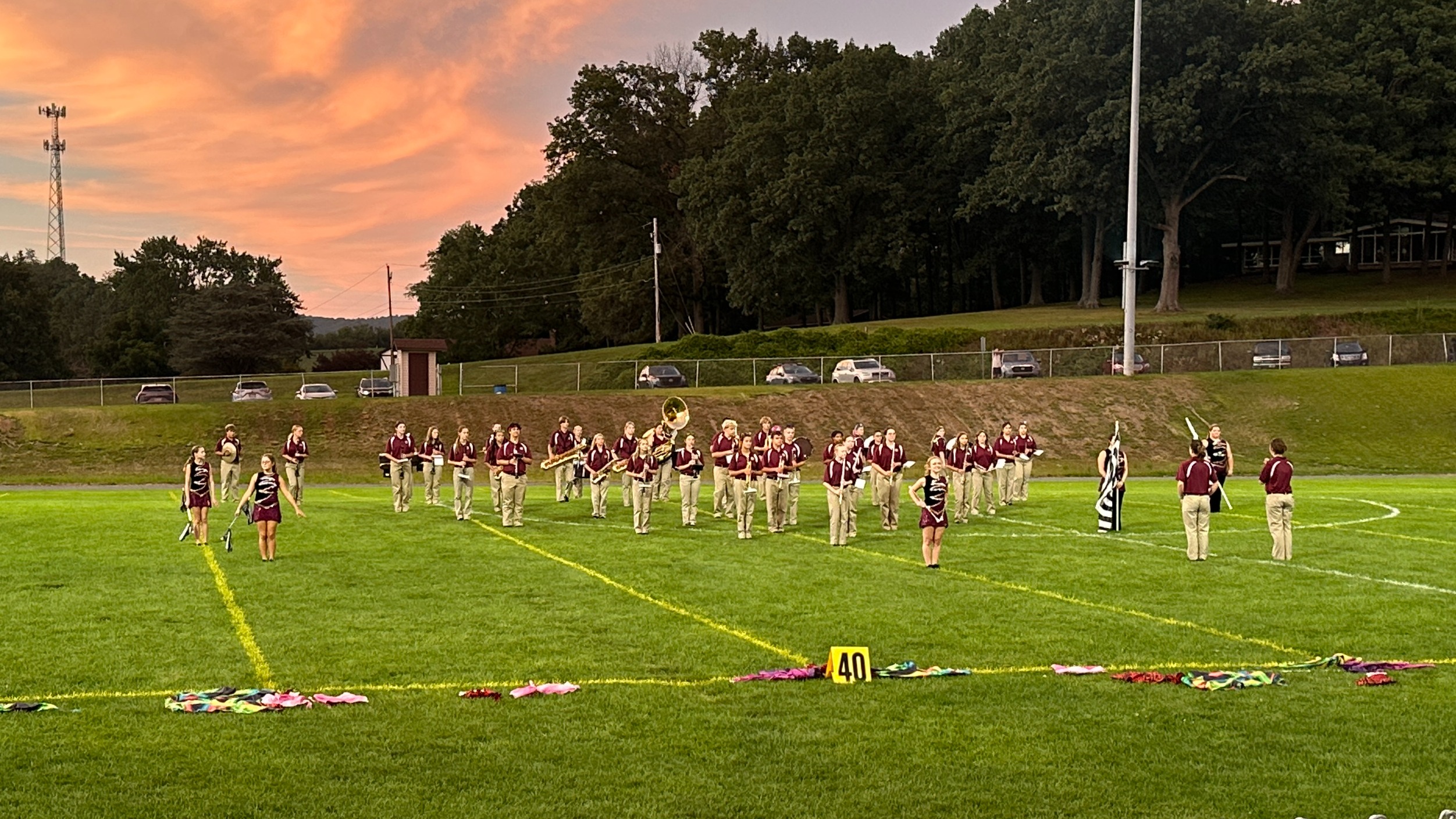 student marching band standing on field
