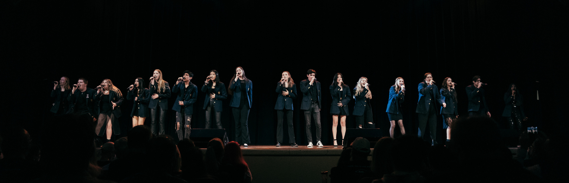 Ramsey High School's a capella group "Ram Jams" performs on stage. 