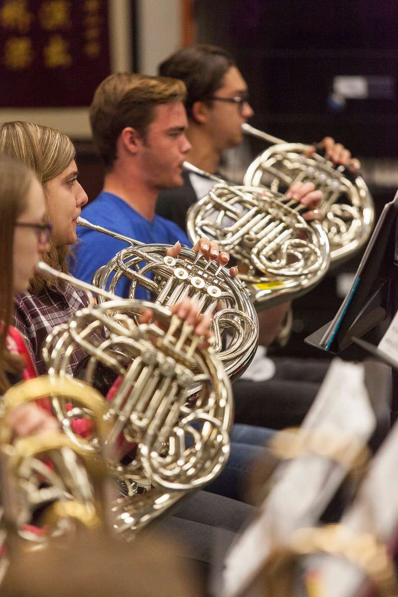 4 students playing french horns