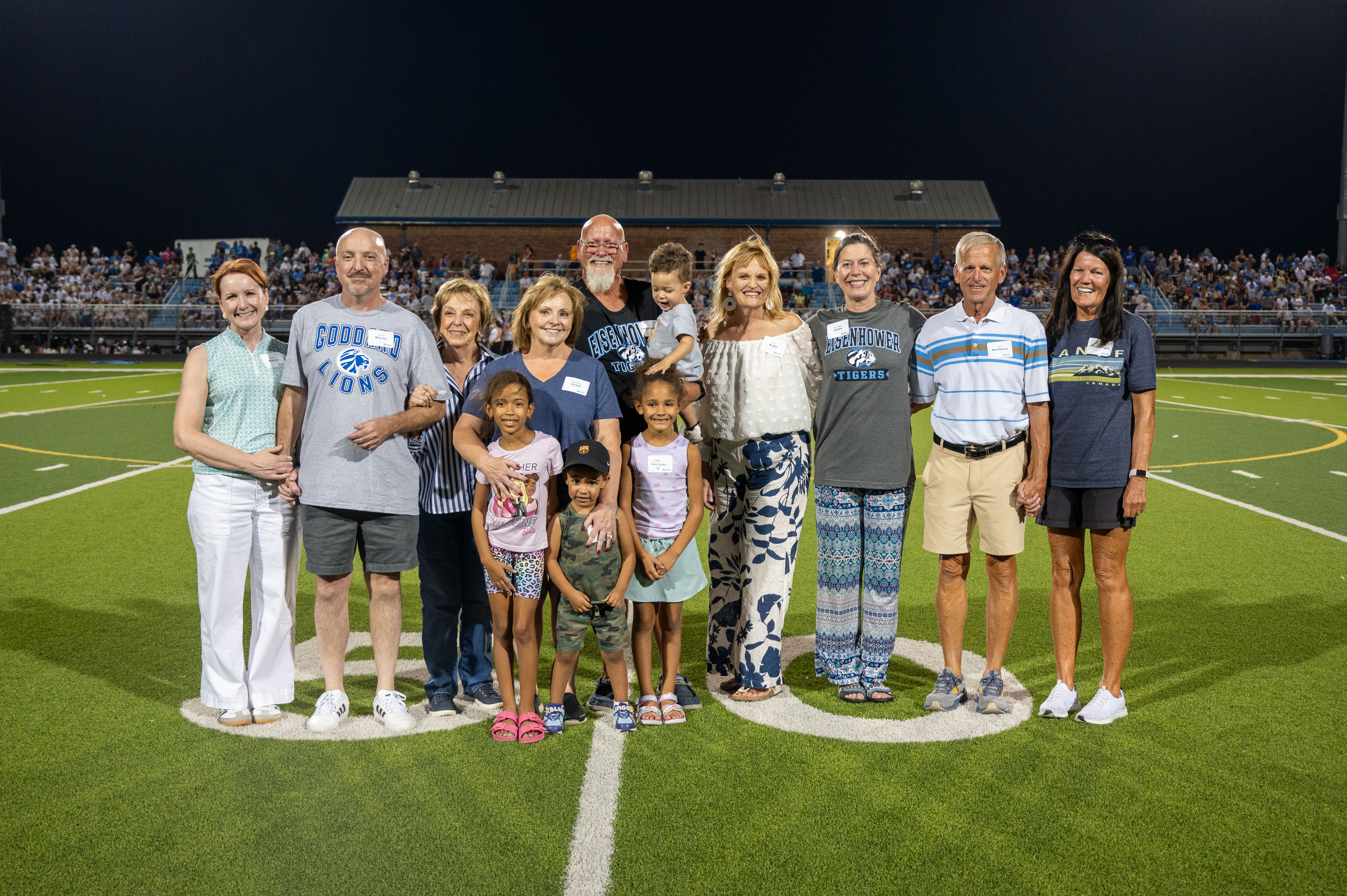 Goddard Public Schools Hall of Fame Class of 2026 honorees and their families pose for a group photo on the football field during halftime of the Roar on 54 football game on September 18, 2026.