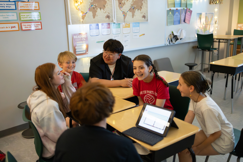 students and a teacher at desks