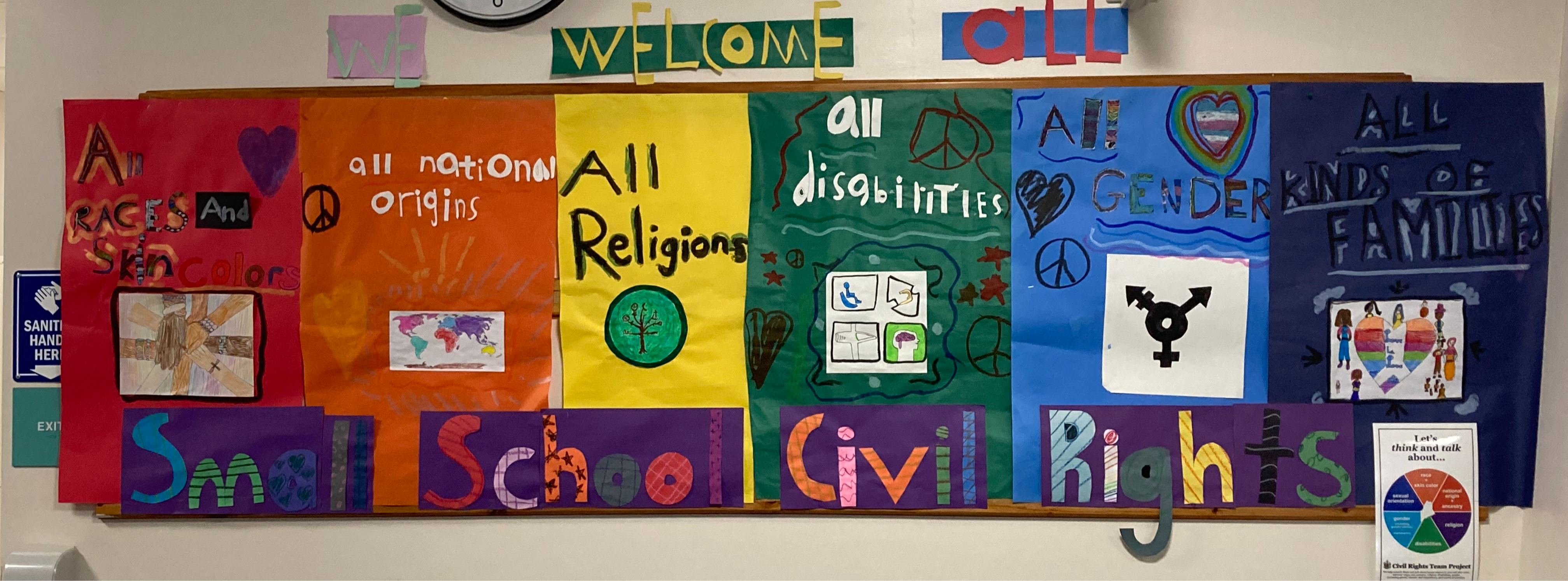 A colorful student-made banner that welcomes all races, national origins, religions, disabilities, genders and types of families