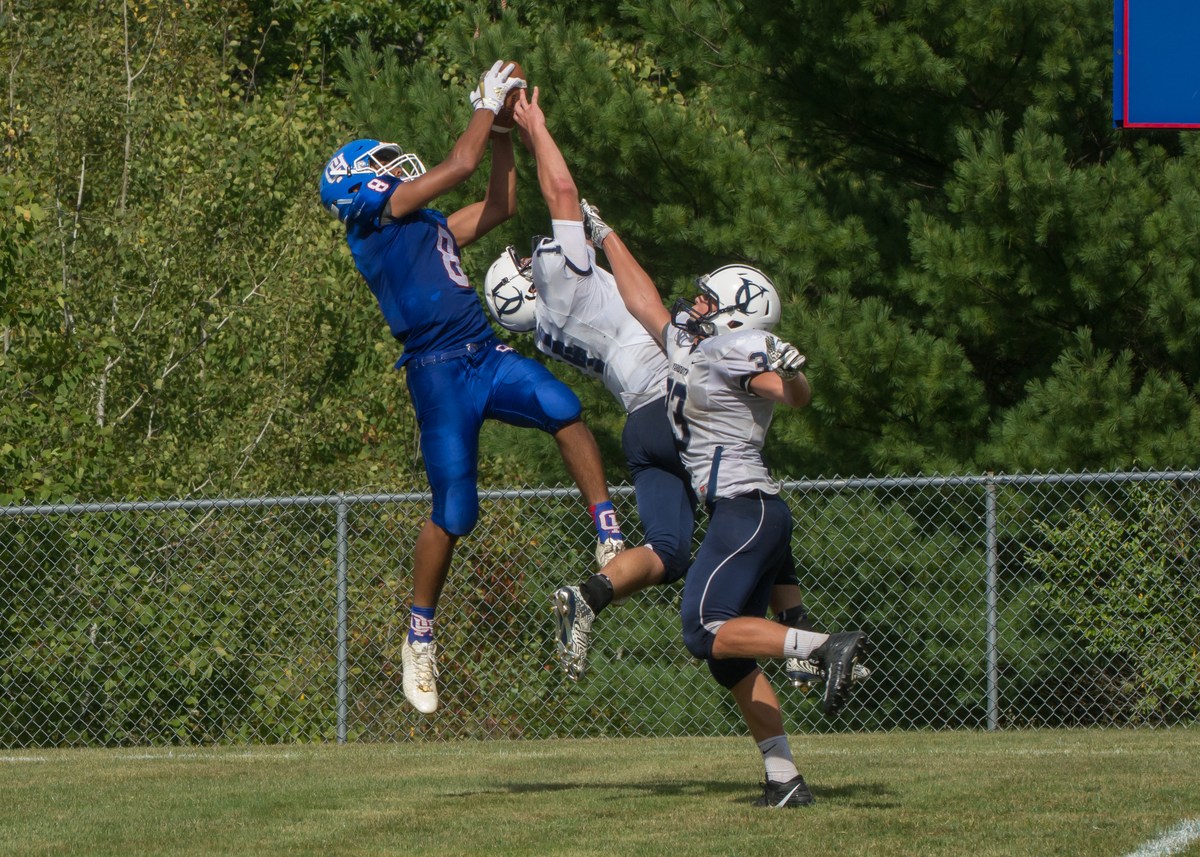 football players jumping for the ball