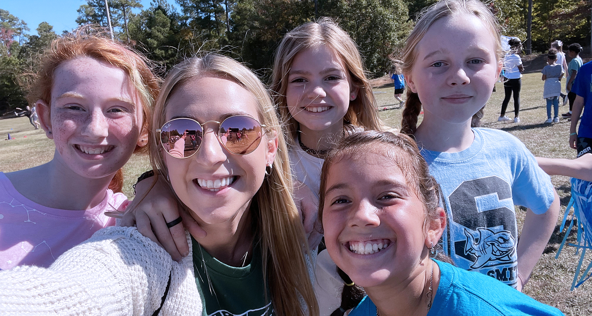 Teacher takes a selfie with four female students.