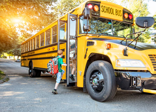 children boarding a school bus