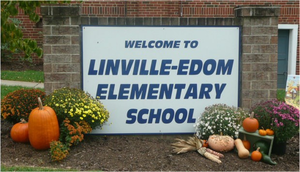 Welcome to Linville-Edom Elementary School. Sign in front of school with pumpkins and gourds around it.