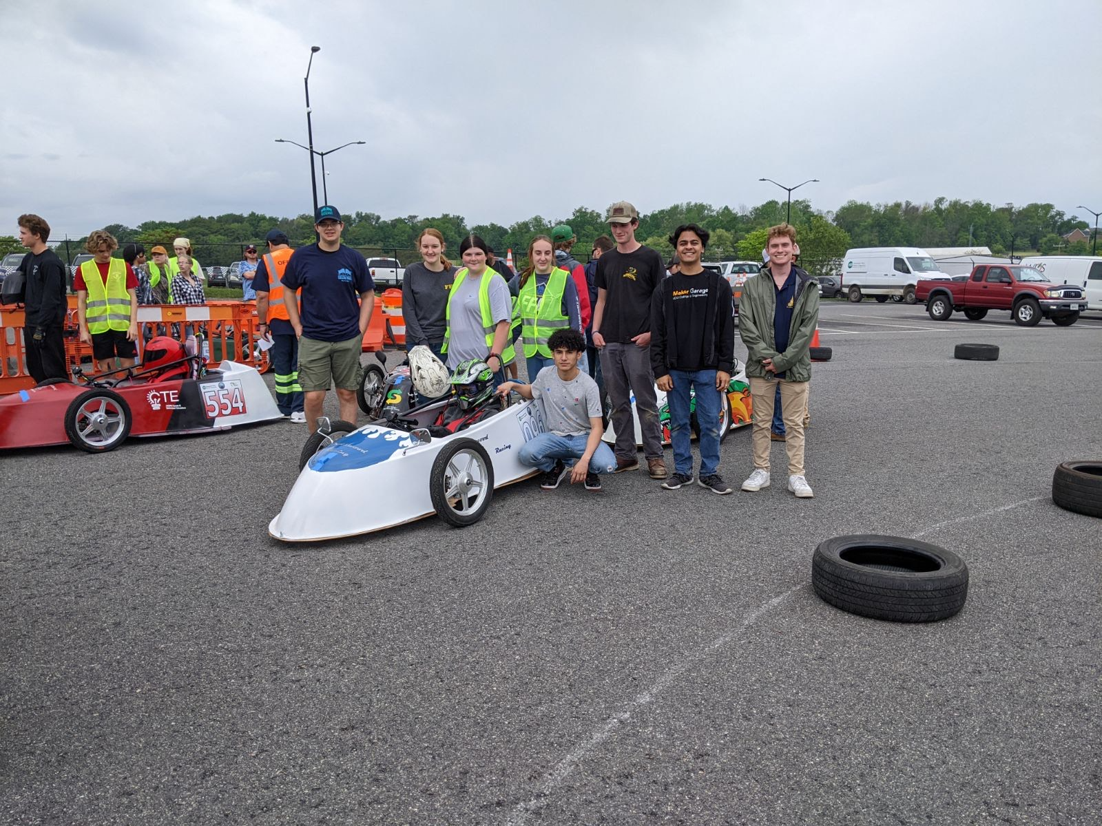 Students with EV car at competition.