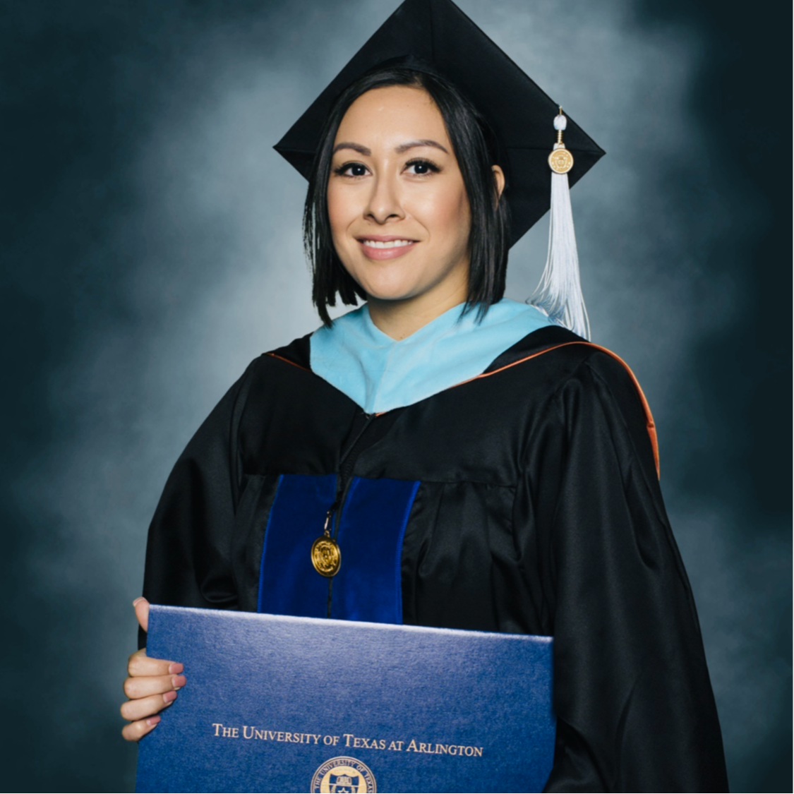 Crystal Padilla in her cap and gown smiling