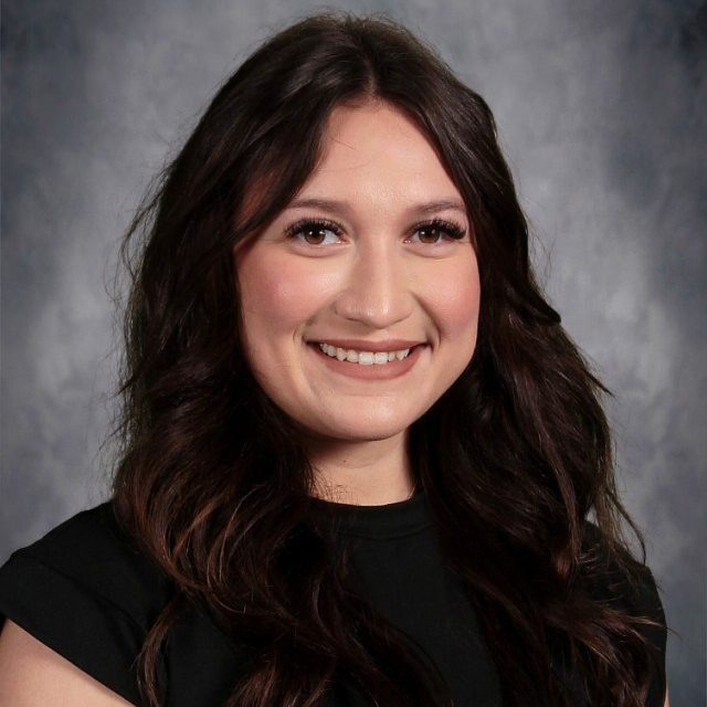 Iridiana Medrano smiling wearing a black blouse in a yearbook headshot