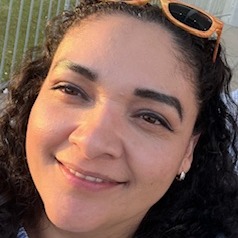 Perla Castillo smiling in her selfie with sunglasses on her head