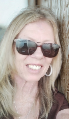 selfie of Carole Manning wearing sunglasses and smiling