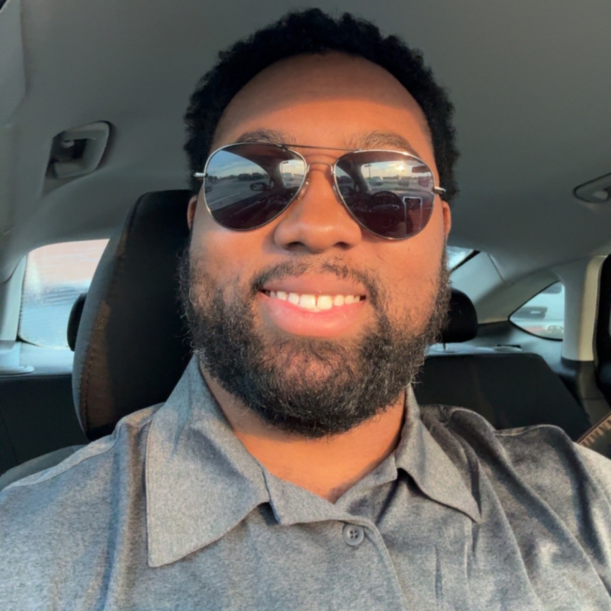 selfie of xavier edwards smiling wearing sunglasses in a vehicle