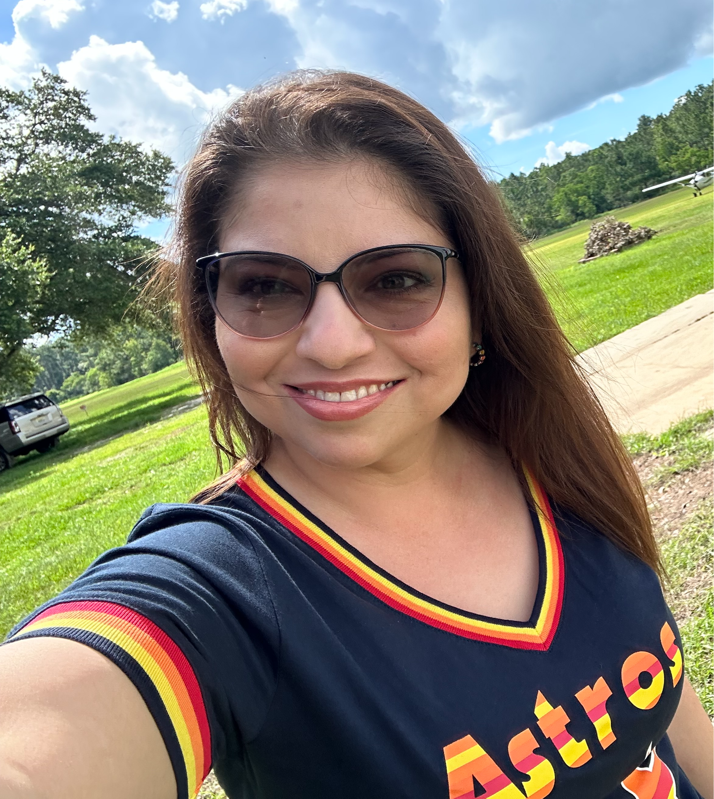 Cristina Molina's selfie wearing sunglasses outdoors and astros gear