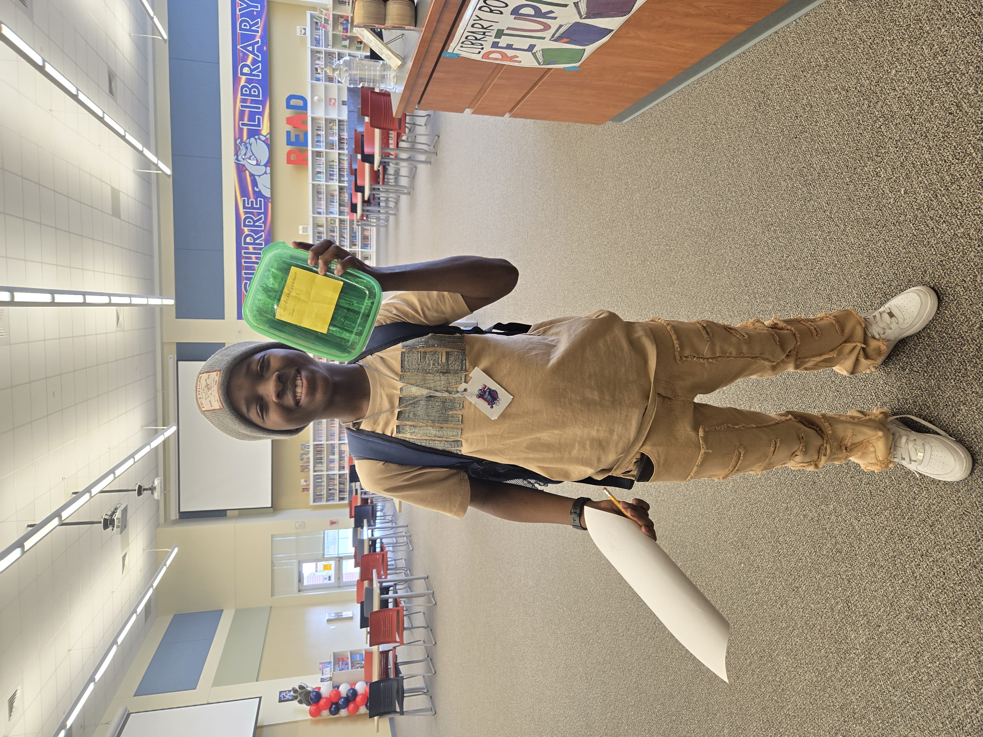 Student posing for Candy Library Waffle with khaki jeans.