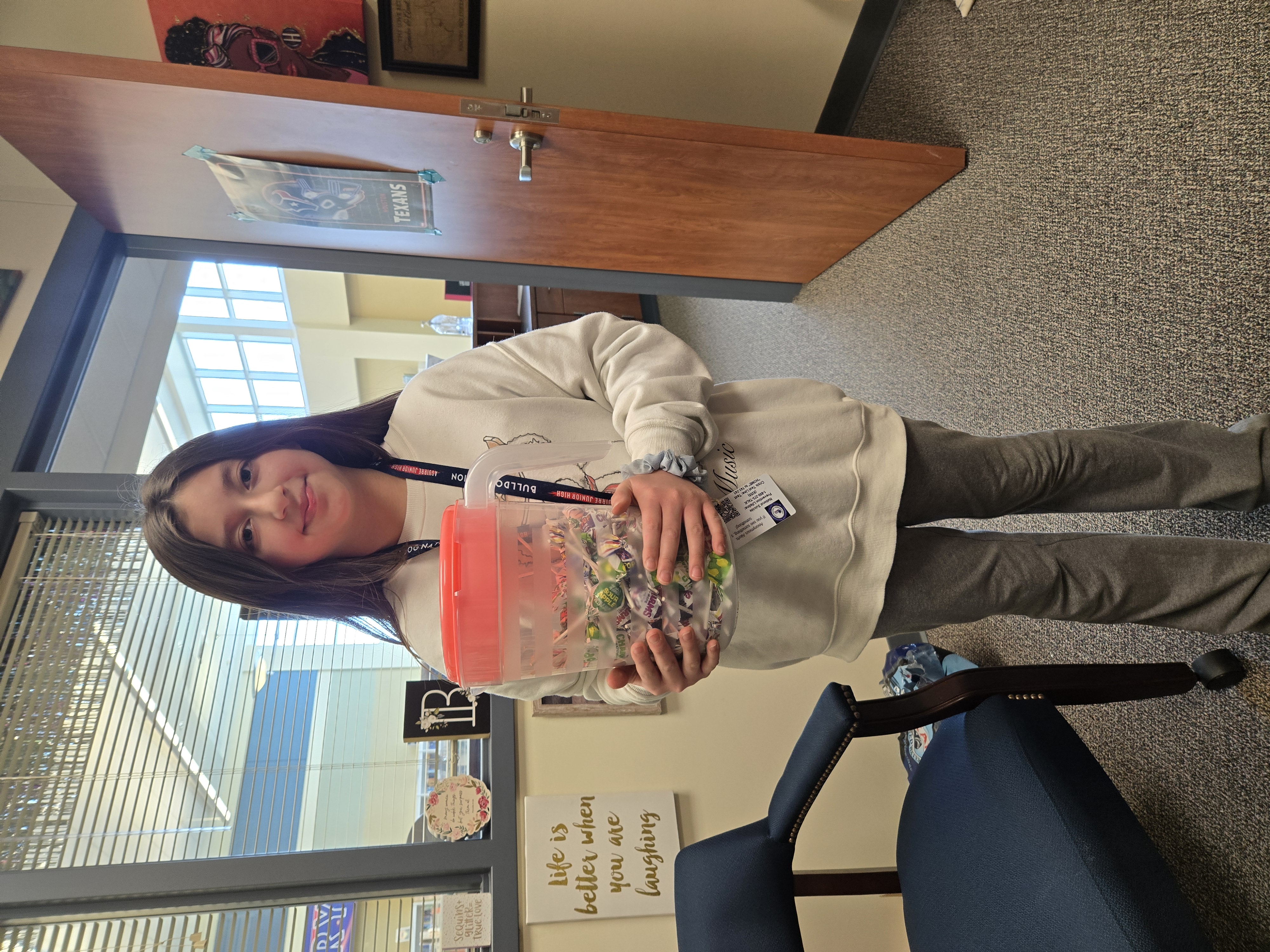 Student posing for Candy Library Waffle with khaki jeans.