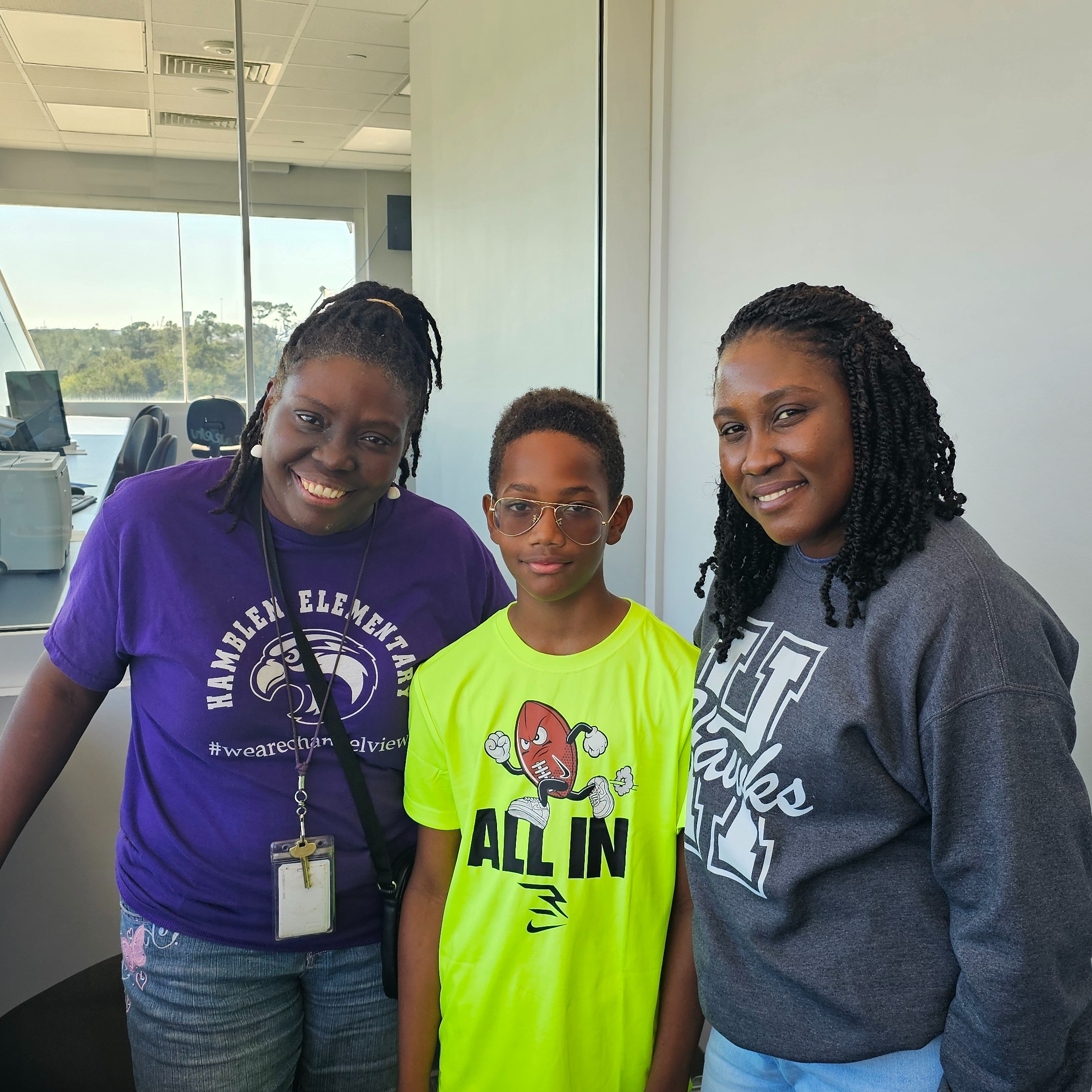 November Student of the Month, Tyris Dancy, stands with his teacher Ms Philemon and the school counselor, Ms Baker