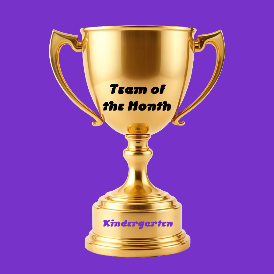 A trophy sits against a purple background  Words on the cup of the trophy read :  Team of the Month.  Words on the trophy's bottom stand read:  Kindergarten