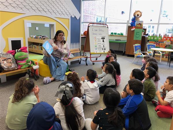 Ms. Lisa reading to a class