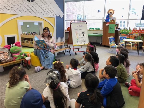 Ms. Lisa reading to a class