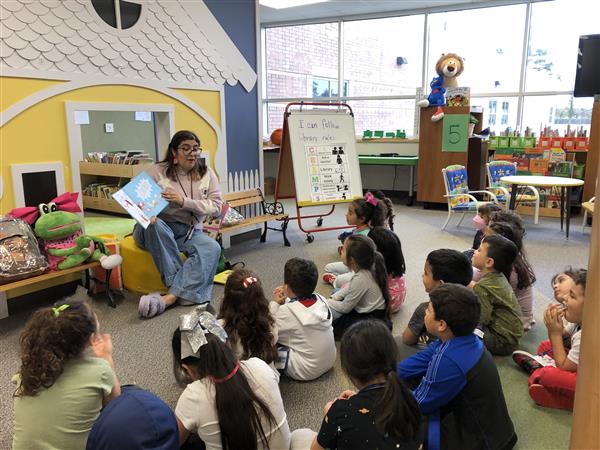 Ms. Lisa reading to a class