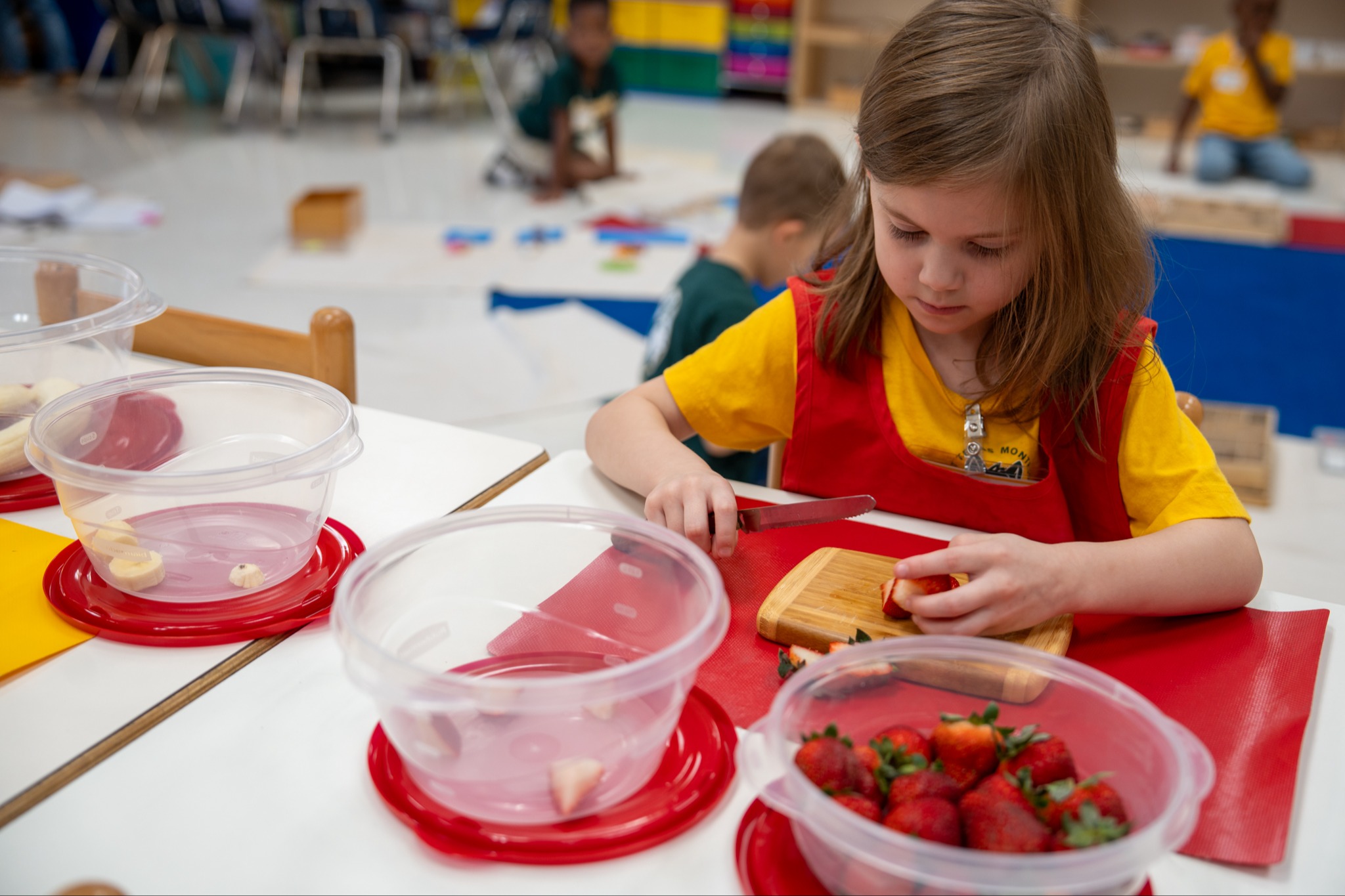 student cutting fruit