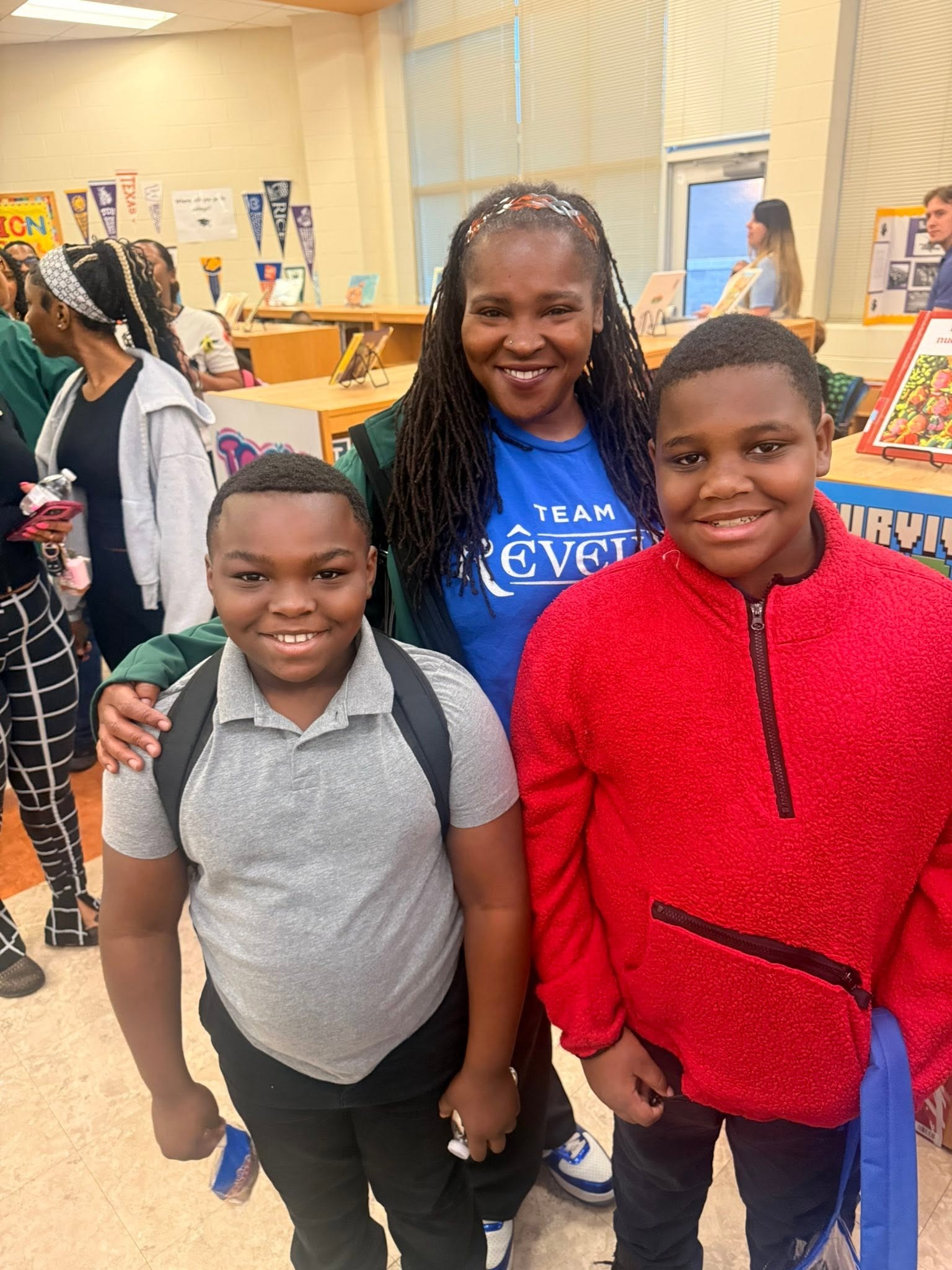 teacher with two students smiling