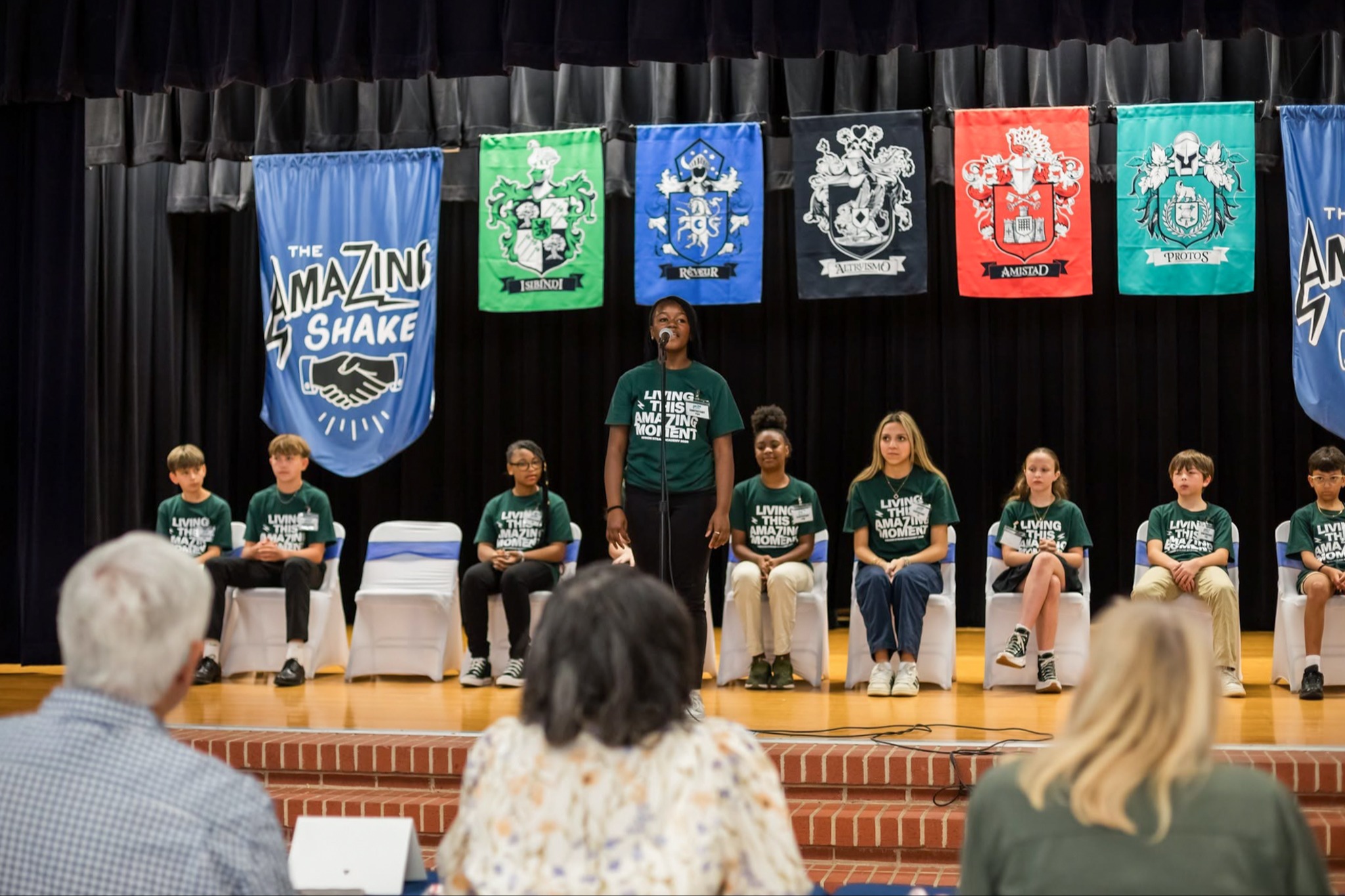 student speaking in front of the school