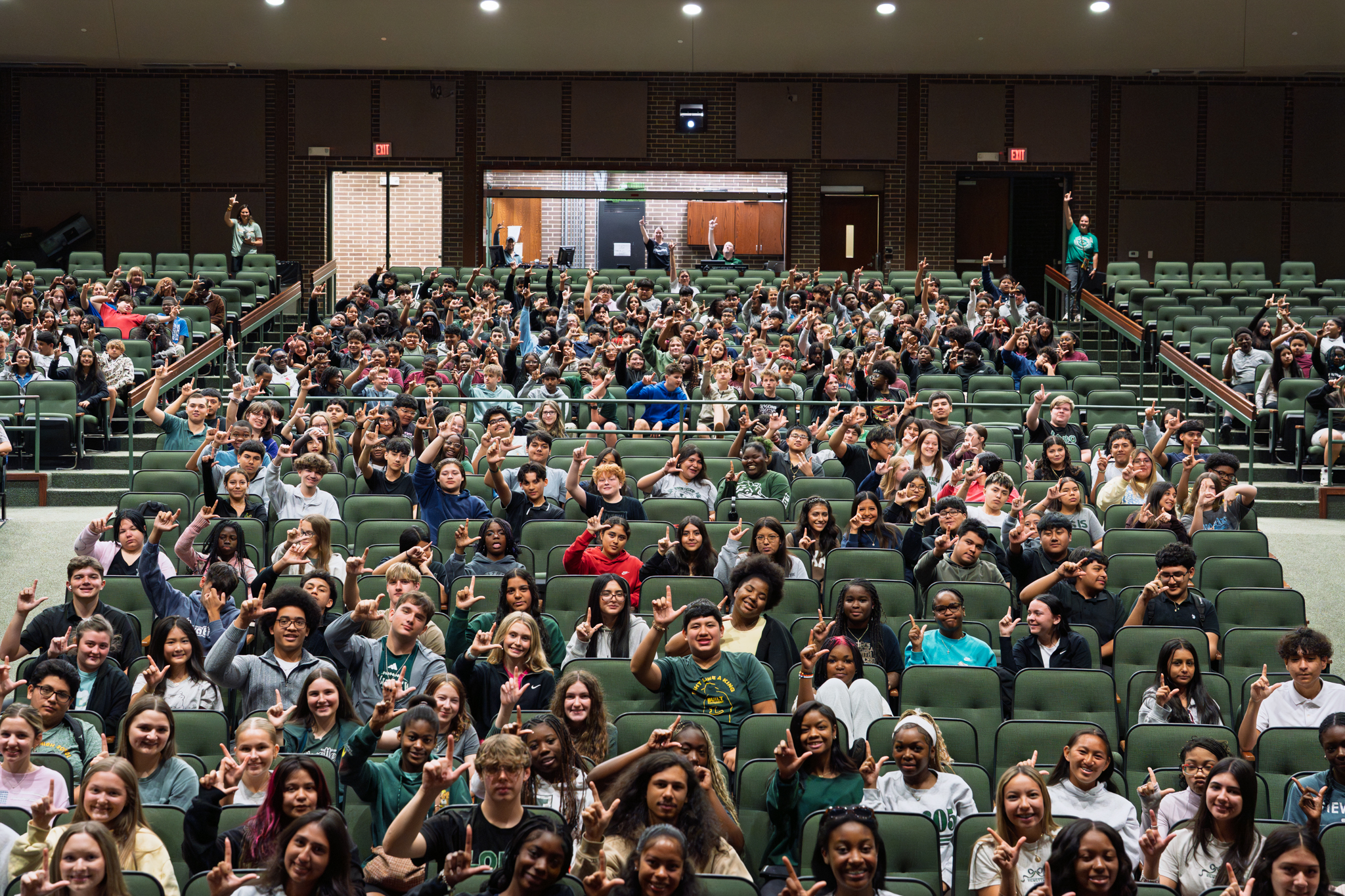 students holding rocking L's